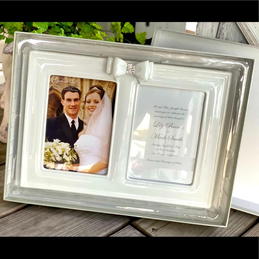 NWT Beautiful new white double picture frame. It has a rhinestone bow. Holds 5x7